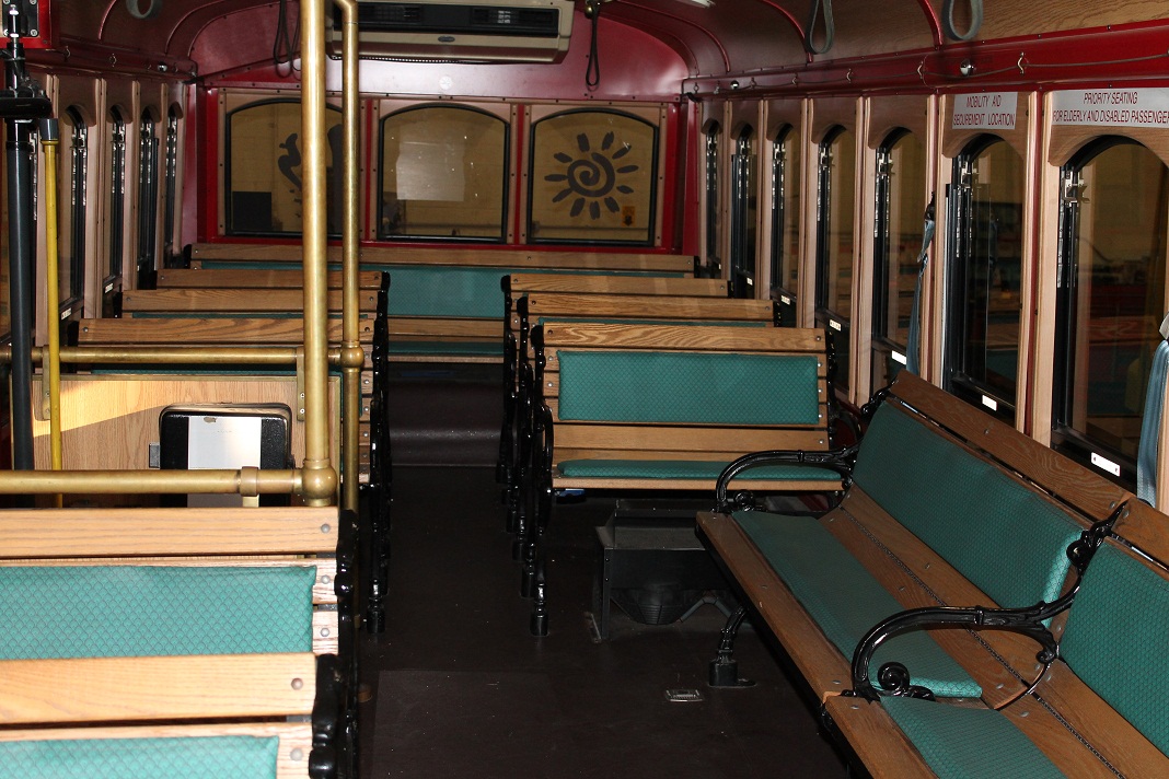 Chance Trolley rental in Philadelphia PA showing wood seats on a 27 passenger vehicle layout for bridesmaids and groomsmen with bride and groom at center of attention
