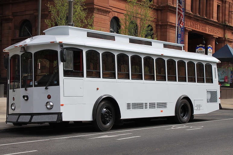 White Victorian Trolley Rental driving up to the Bourse Building for Special Day Service for Wedding Bride and Groom Summer time heading to Cescaphe ballroom Philadelphia